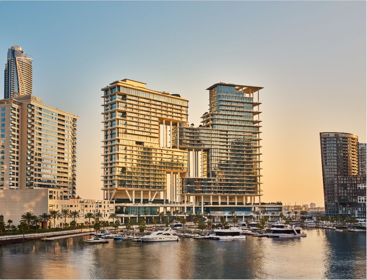 Waterfront towers beside a marina in Dubai at golden hour