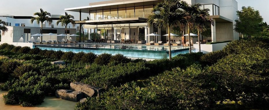 Clubhouse with a swimming pool surrounded by palms