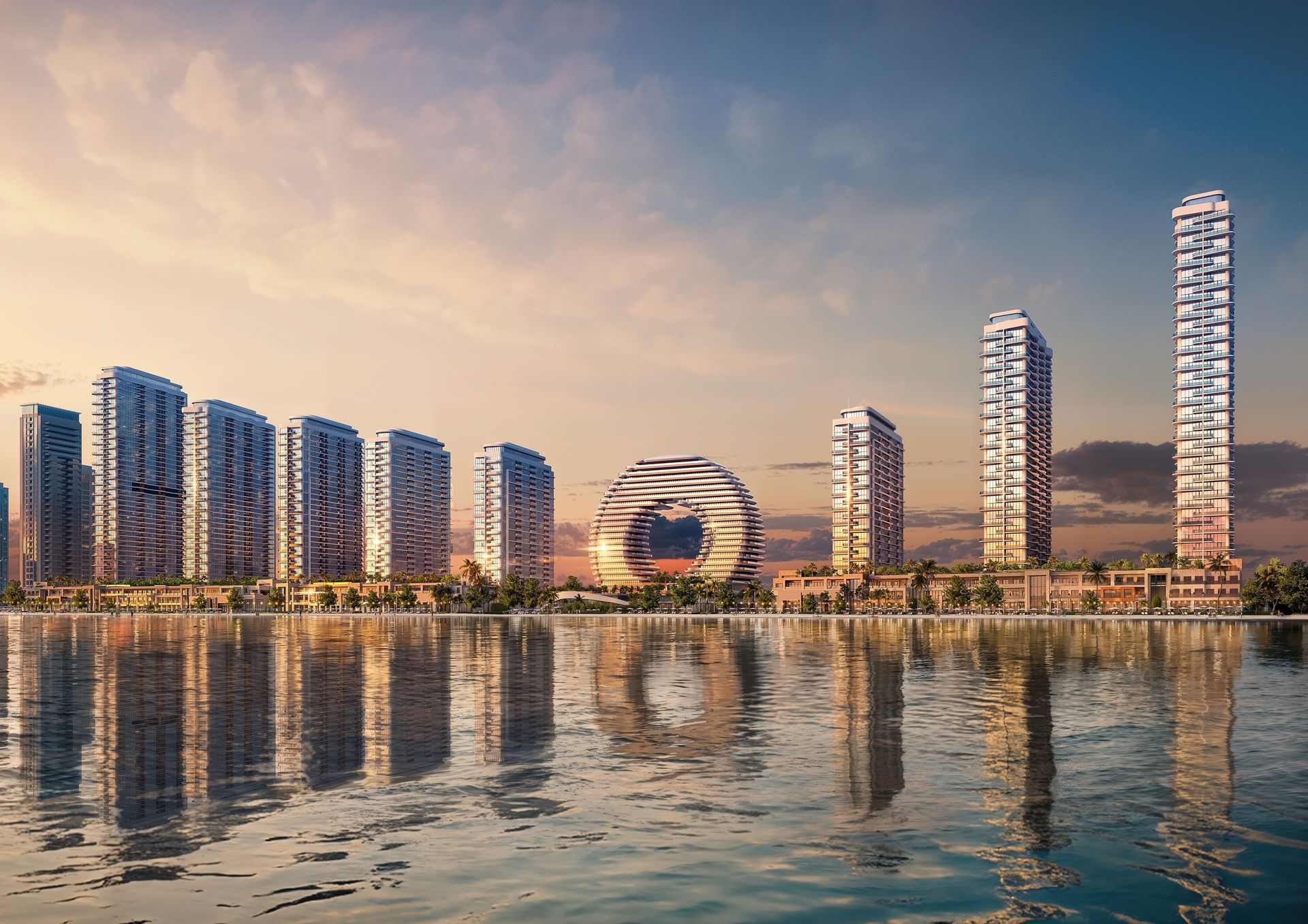 Waterfront towers reflected in calm water at sunset